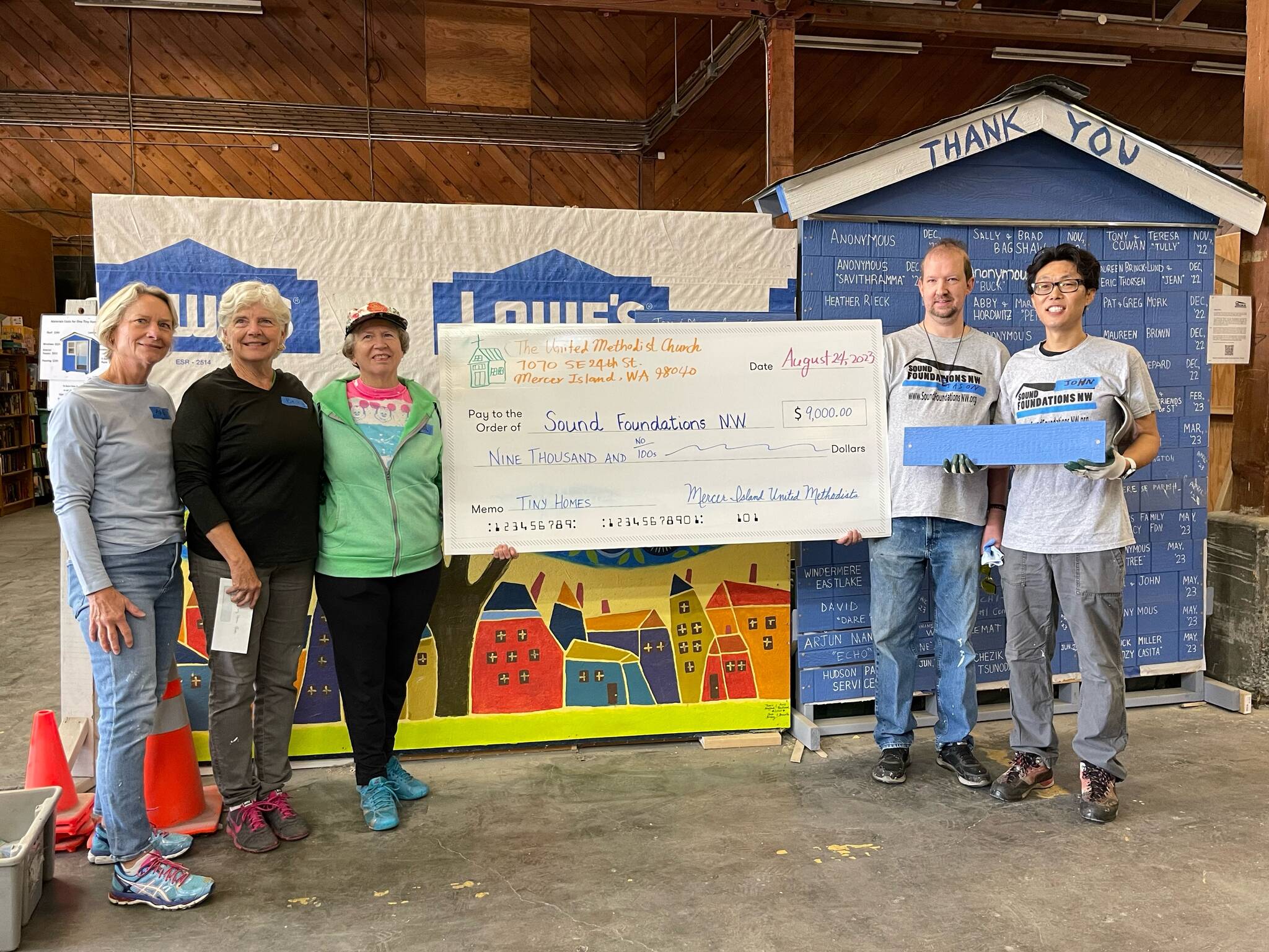 Members of the Mercer Island United Methodist Church raised $9,000 at its Jazz for Tiny Homes student-run concert to help the homeless on Aug. 22 at the church. The check was presented to Sound Foundations NW on Aug. 24. Pictured, in part, are: from second left to right, Becky Dudley, Carol Mariano, Jeff Maners and John Go. About 100 people attended the fundraising event, which featured Mercer Island High School students performing jazz music and an Eastside-based indie rock band unleashing its tunes in the Fellowship Hall. Grace Go and Ryan Hsi were the key event planners. Photo courtesy of Brooks Kahsai