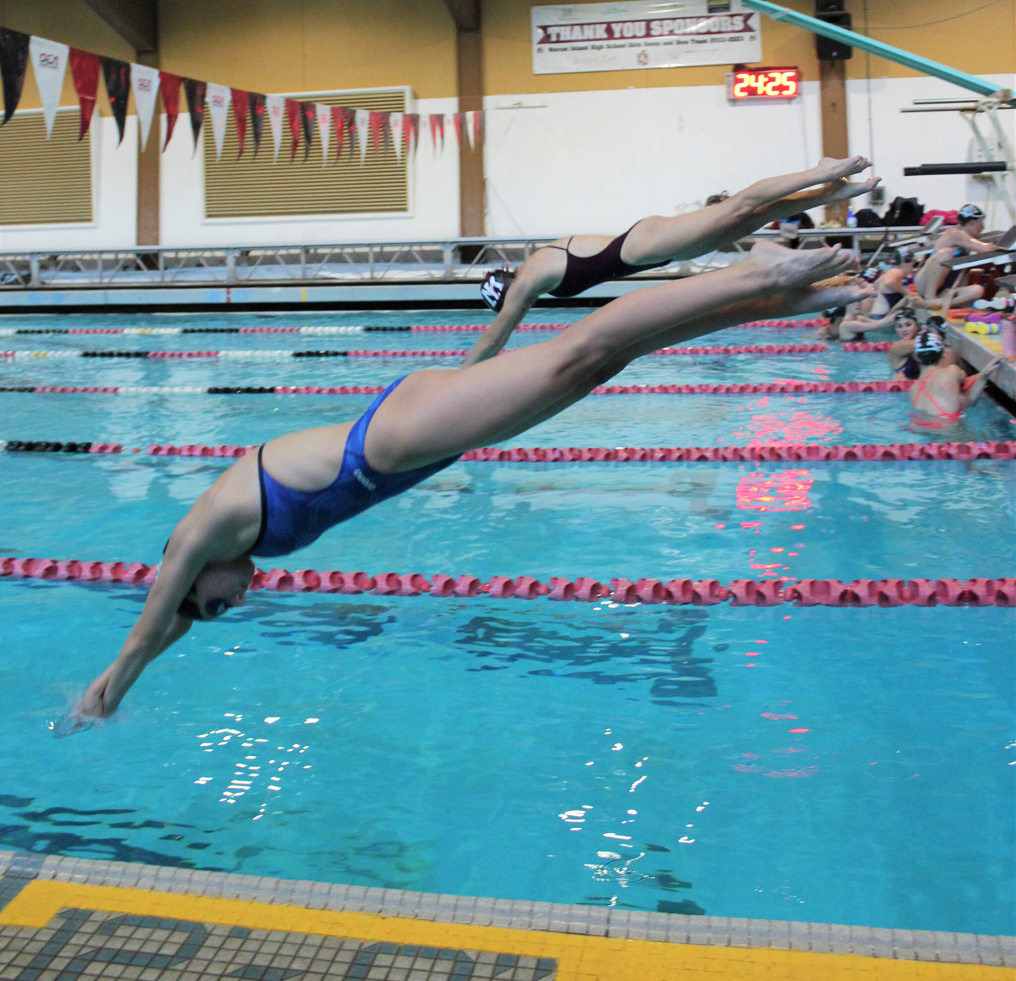 Gracyn Kehoe, front, and a teammate dive off the starting block into Mary Wayte Pool during a recent practice. Courtesy photo