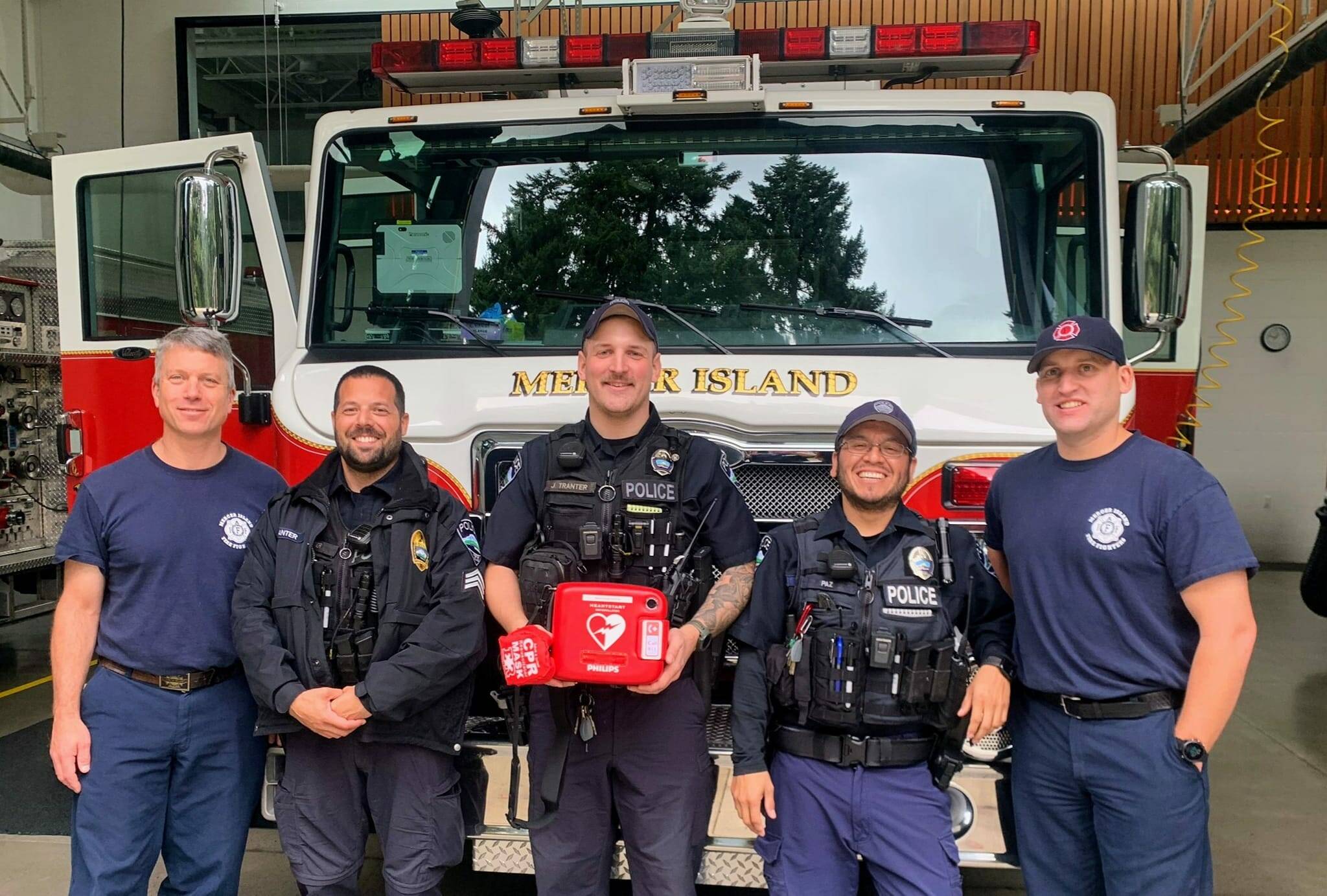 The Mercer Island Fire Department recently secured brand new, lifesaving AED (automated external defibrillator) devices for Mercer Island Police Department officers to utilize in every police patrol vehicle and on board its Marine Patrol boats. Officers are all first-aid trained and are immediately dispatched to every medical call involving a cardiac arrest. Officers are often already driving around the Island and can arrive to the scene ahead of the fire trucks and begin CPR. “This teamwork between us and our fire department can mean the difference between life and death when every minute counts,” the police department noted. Pictured are, from left to right, fire department Lt. Ray Austin, the police department’s Sgt. David Canter, officer Jordan Tranter and officer Luiz Paz and firefighter Joe White. Photo courtesy of the Mercer Island Police Department