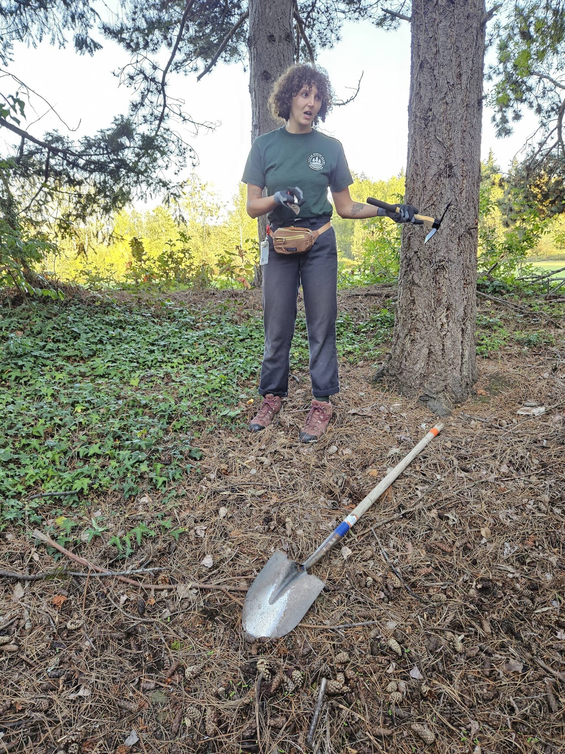 Courtesy photo
Jordan Fisher of the city’s Parks and Recreation Department demonstrates best tools for removing ivy.