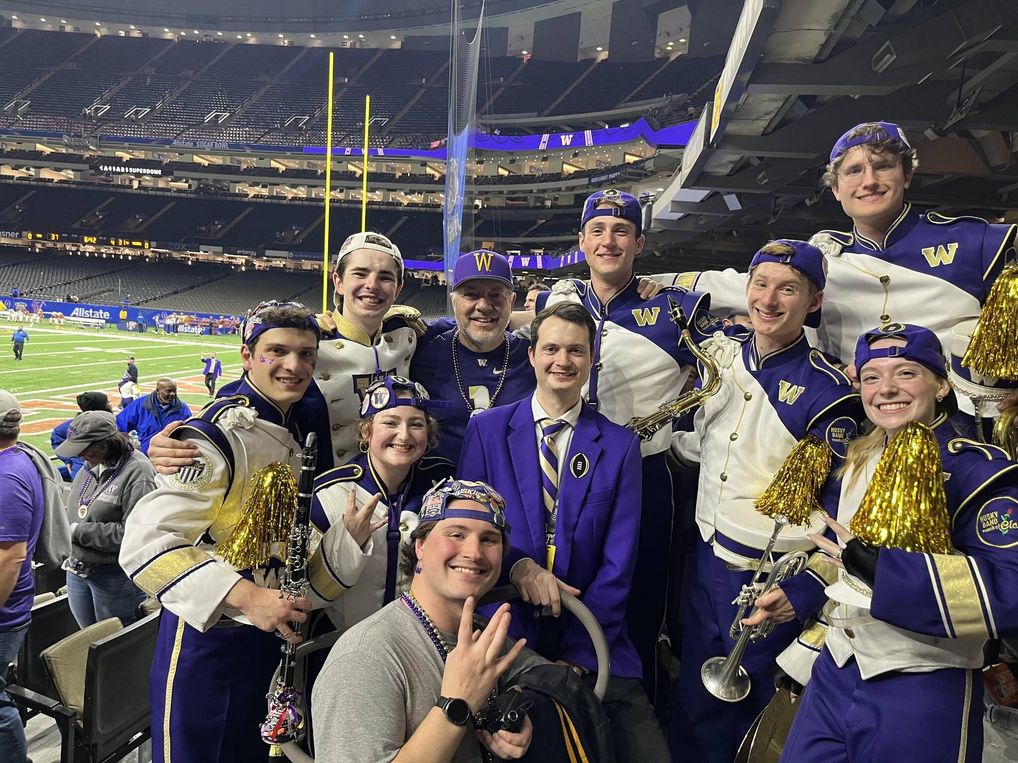 Islander Middle School band director and Mercer Island School District fine arts coordinator David Bentley (donning a W hat) connected with Mercer Island High School band alumni that are part of the University of Washington band at the Sugar Bowl football game in New Orleans on Jan. 1. No. 2-ranked UW (14-0) beat Texas, 37-31, and will battle top-ranked Michigan (14-0) for the national championship on Jan. 8 in Houston. Also pictured are: Lauren Majewski, alto saxophone; Dylan Majewski, band alum; Aaron Levin, tenor saxophone; Jake Levin, trumpet; Camilla Gaugush, drumline; David Stewart, assistant director; Marcus Valentin, mellophone; Bridger Bourke, drum major; and Thomas Mangold, clarinet. Photo courtesy of the Mercer Island School District