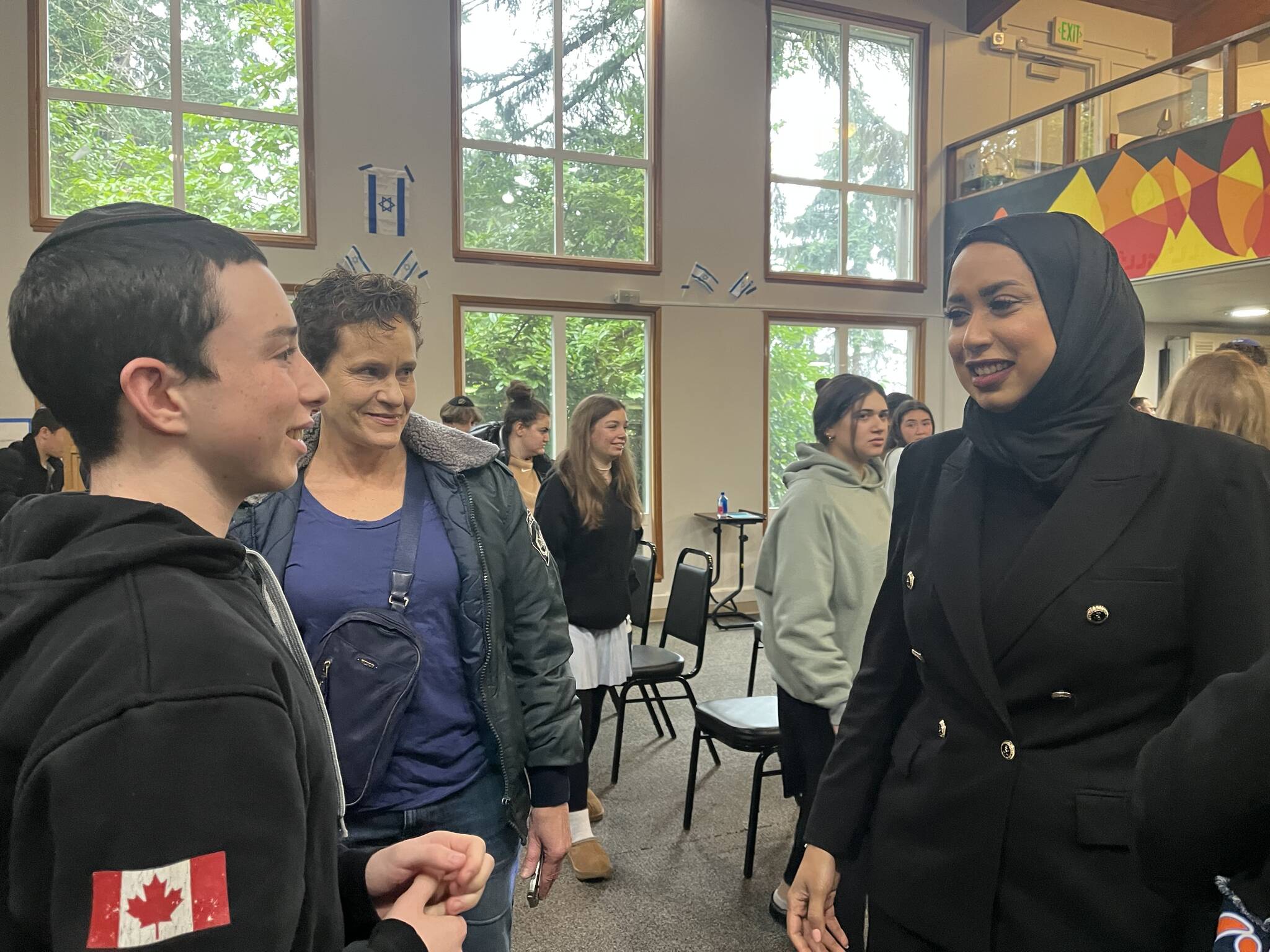 Northwest Yeshiva High School junior Izzy Hoffman, left, speaks with Fatema Al Harbi, right, Gulf Affairs director at Sharaka, on Jan. 26 at the Mercer Island school. Sharaka — which means partnership in Arabic — is a nonprofit and nongovernmental organization working to shape a new Middle East, built on dialogue, understanding, cooperation and friendship. Photo courtesy of Northwest Yeshiva High School