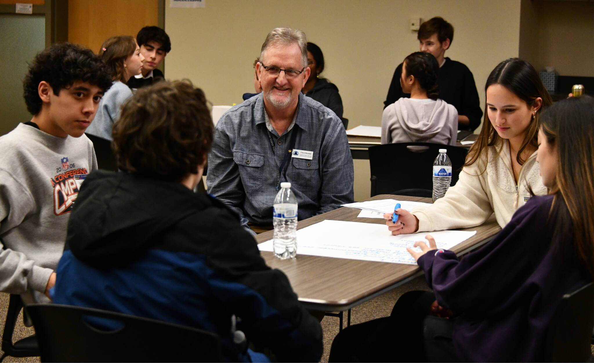 Mercer Island Youth and Family Services Mercer Island High School prevention specialist Chris Harnish, center, interacts with students during a MI Healthy Youth Forum breakout session on Jan. 31 at the Mercer Island Community and Event Center. Andy Nystrom/ staff photo