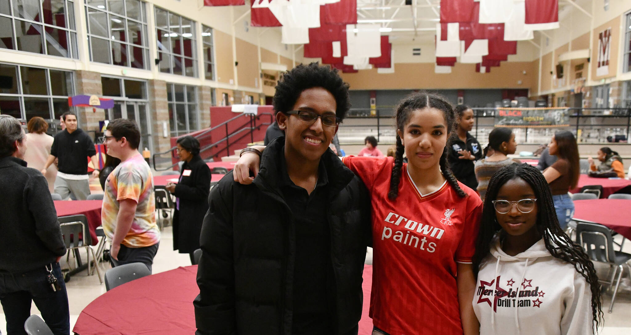 From left to right, Mercer Island High School Black Student Union members Tewodros (Teddy) Sanchez-Alemu, Jada Jorgensen and Omolara Olusanya gather at the union’s community dinner on Feb. 7 in the school commons. Andy Nystrom/ staff photo