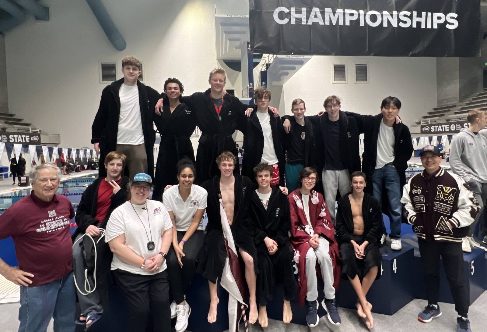Mercer Island High School athletes and their coaches gather poolside at the recent 3A boys state swim and dive championships at the King County Aquatics Center in Federal Way. Courtesy photo