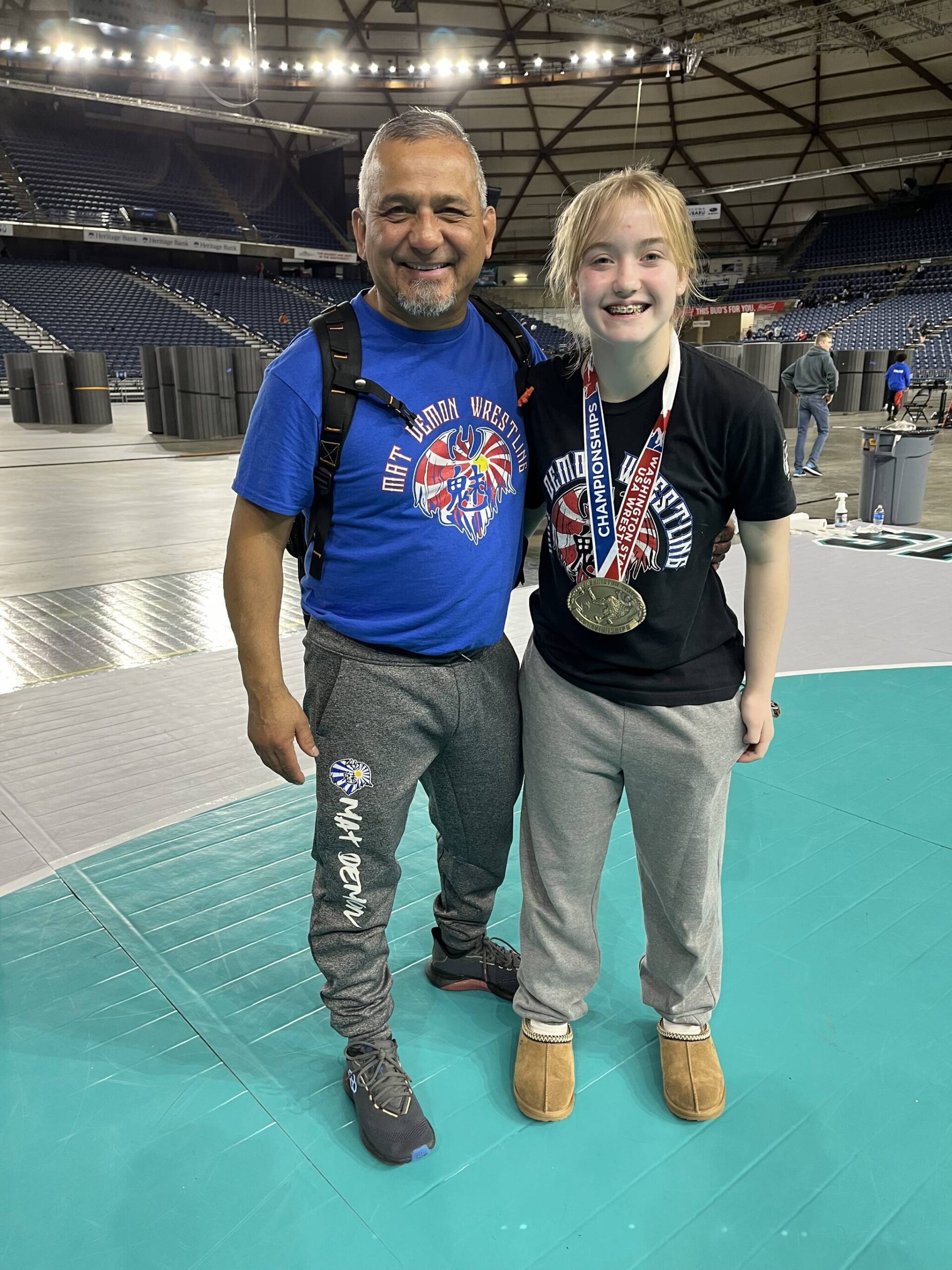Mercer Island’s Emerson Woods with coach Jess Torres at the Washington State Wrestling Folkstyle Championships on Feb. 18 at the Tacoma Dome. Woods notched the 121-pound middle school girls title. Courtesy photo