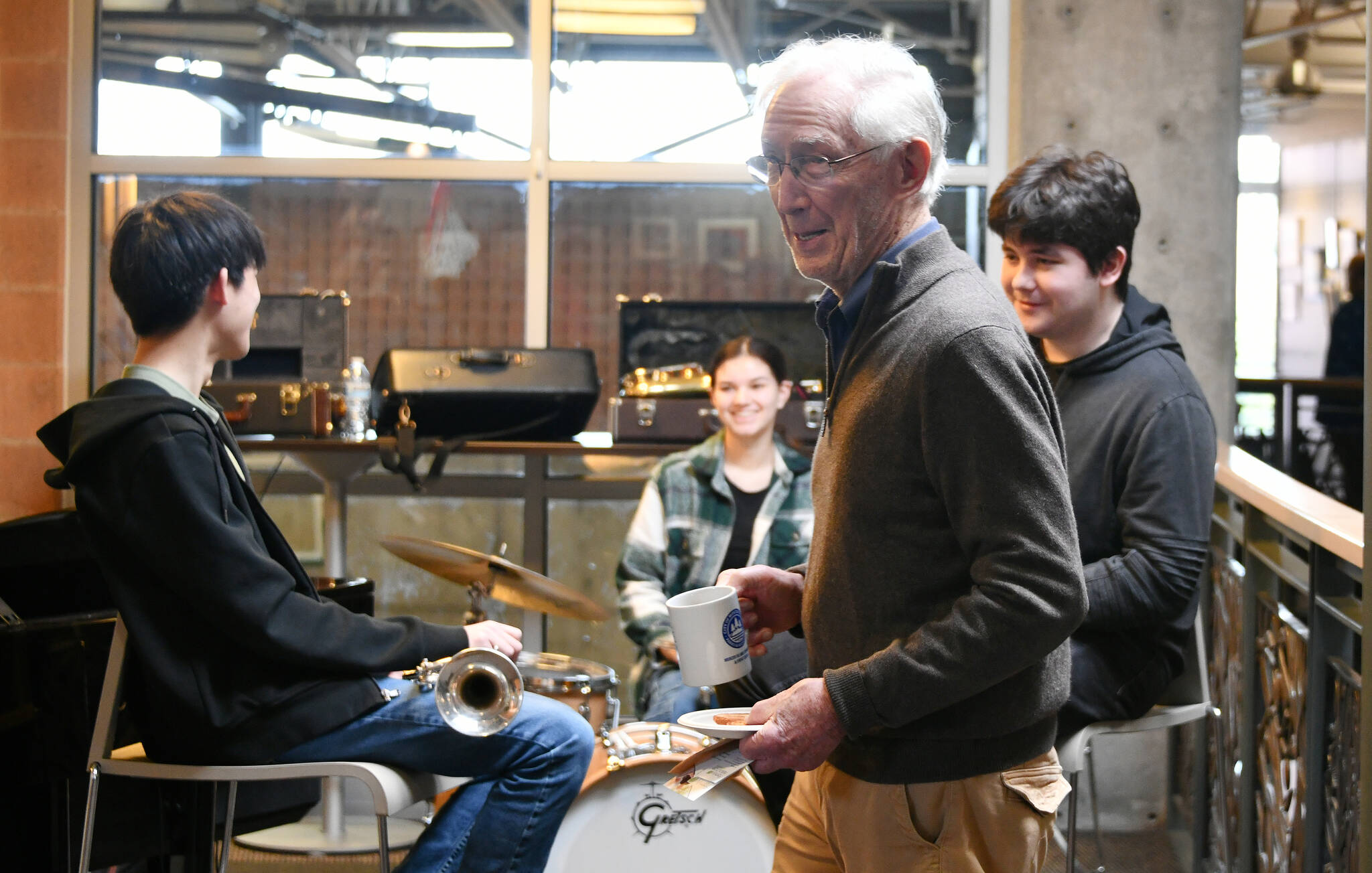 Fletch Waller, a volunteer with Wider Horizons, visits with Music in the Community club jazz band members and Mercer Island High School students, from left, Giovanni Ng (trumpet), Alanna Larson (drums) and Elliott Yaroslavsky (trumpet) at the city of Mercer Island’s Senior Resource Fair on March 2 at the Mercer Island Community and Event Center. Not pictured: Ashwin Krishnaswamy (piano). Waller, whose grandson plays in the high school jazz band, joined a plethora of attendees at the event, which featured 45 vendors, including Aegis Living/Mercer Island, Aljoya Mercer Island, Covenant Living at the Shores, PT Solutions Physical Therapy, Elderwise and more. Aegis and Belle Harbour sponsored the event. Andy Nystrom/ staff photo