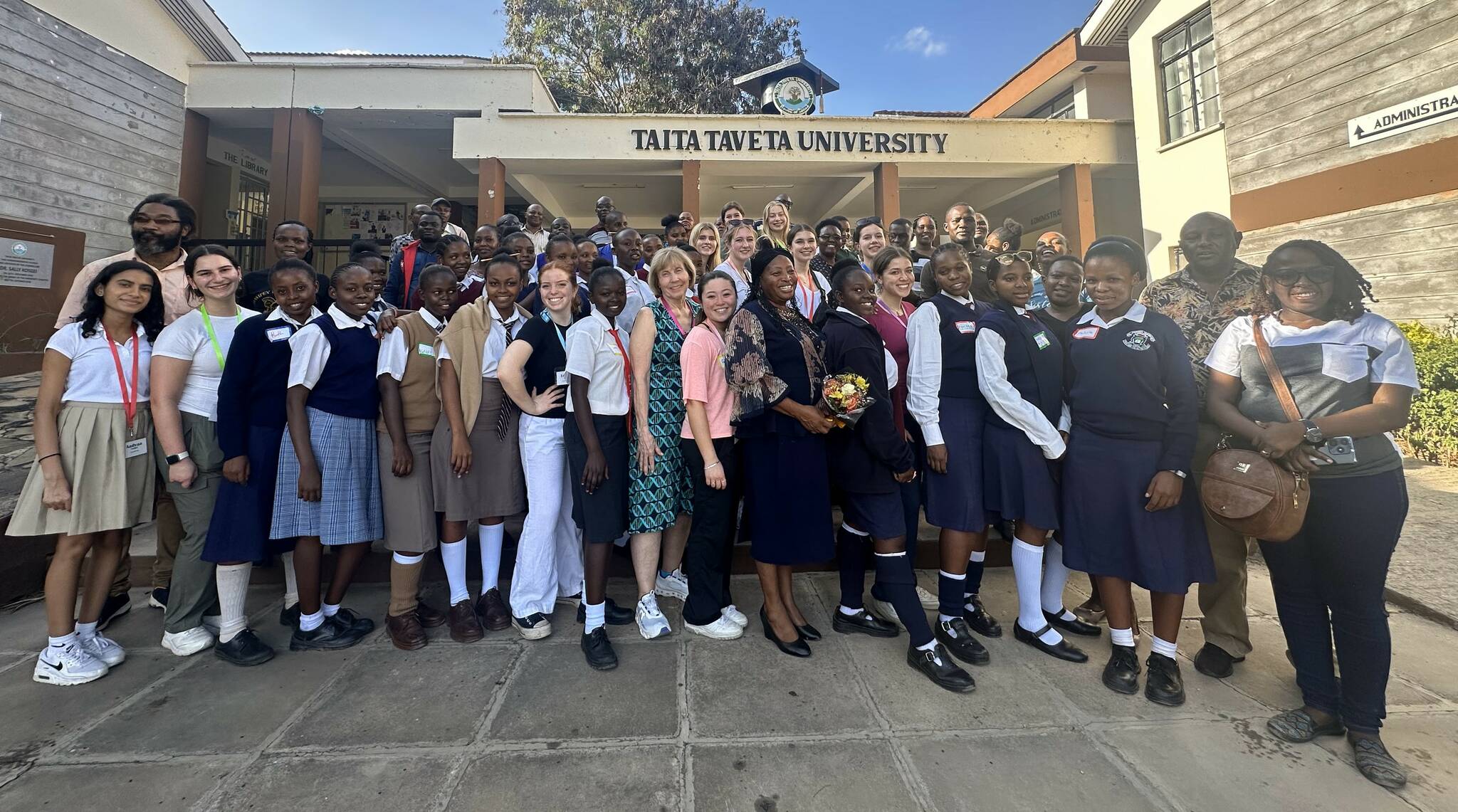 PETRI and Girls to Girls members stand in front of Taita-Taveta University, where they taught Kenyan high school scholars a science lab about cancer genes in elephants. Photo courtesy of Kimberly Miyazawa Frank