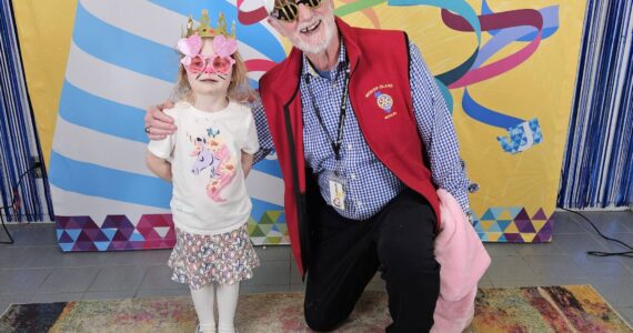 Esme Parks, 5, and John Hamer, 77, at the Purim Festival on March 24. Courtesy photo