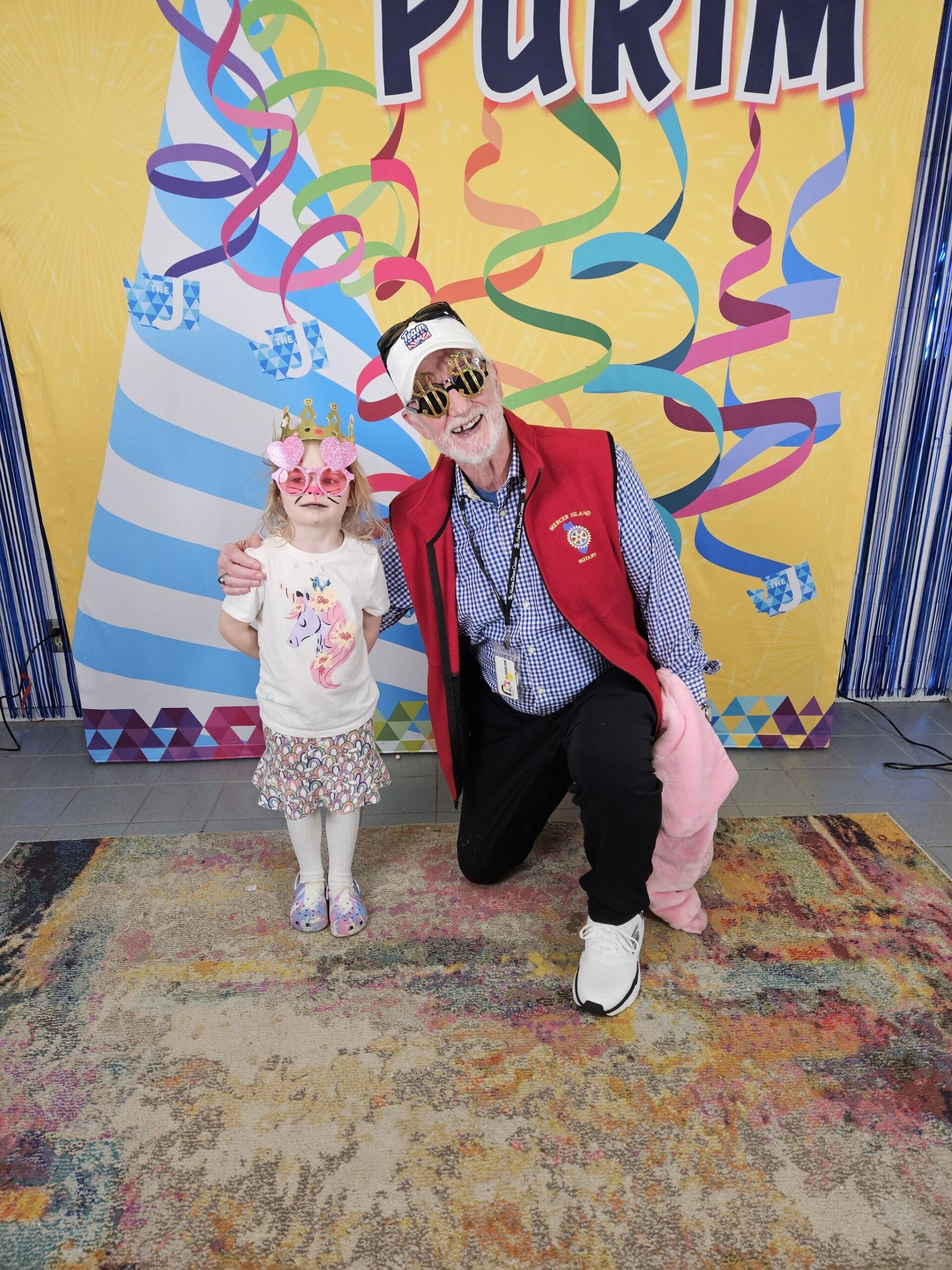 Esme Parks, 5, and John Hamer, 77, at the Purim Festival on March 24. Courtesy photo