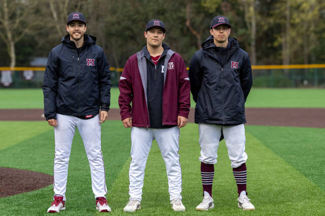 Left to right, Mercer Island High School (MIHS) varsity baseball head coach Chris Lawler and assistant coaches Keegan Ogard and Michael Petrie gather at the MIHS baseball alumni and fan appreciation night on April 4 at Island Crest Park. All are MIHS class of 2014 alums. Photo courtesy of Bernard Mangold