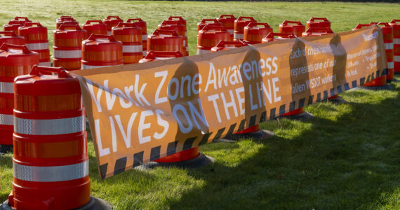 Sixty-one orange traffic barrels were set up April 2, 2024, on the WSDOT front lawn in Olympia. Each cone represents a fallen WSDOT employee killed on the job since 1950 - many in active work zones. The visual display is meant to remind everyone of the importance of slowing down in work zones. Photo courtesy of Washington State Department of Transportation.