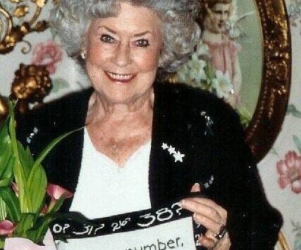 Greg’s late mother holding a pillow with her signature saying. Photo courtesy of Greg Asimakoupoulos