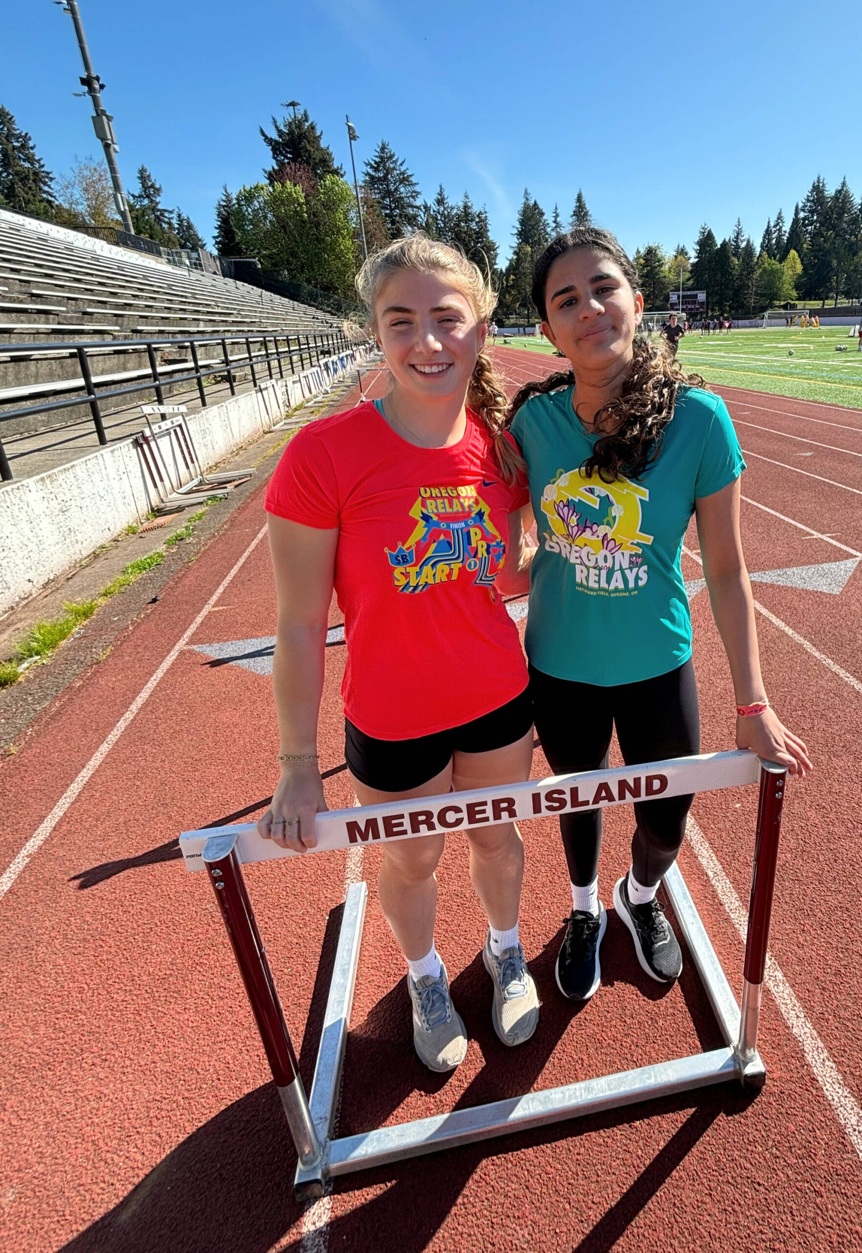 Mercer Island High School sophomores Eloise Newman, left, and Aaliyah Khan take a break from track and field training on April 22. Andy Nystrom/ staff photo