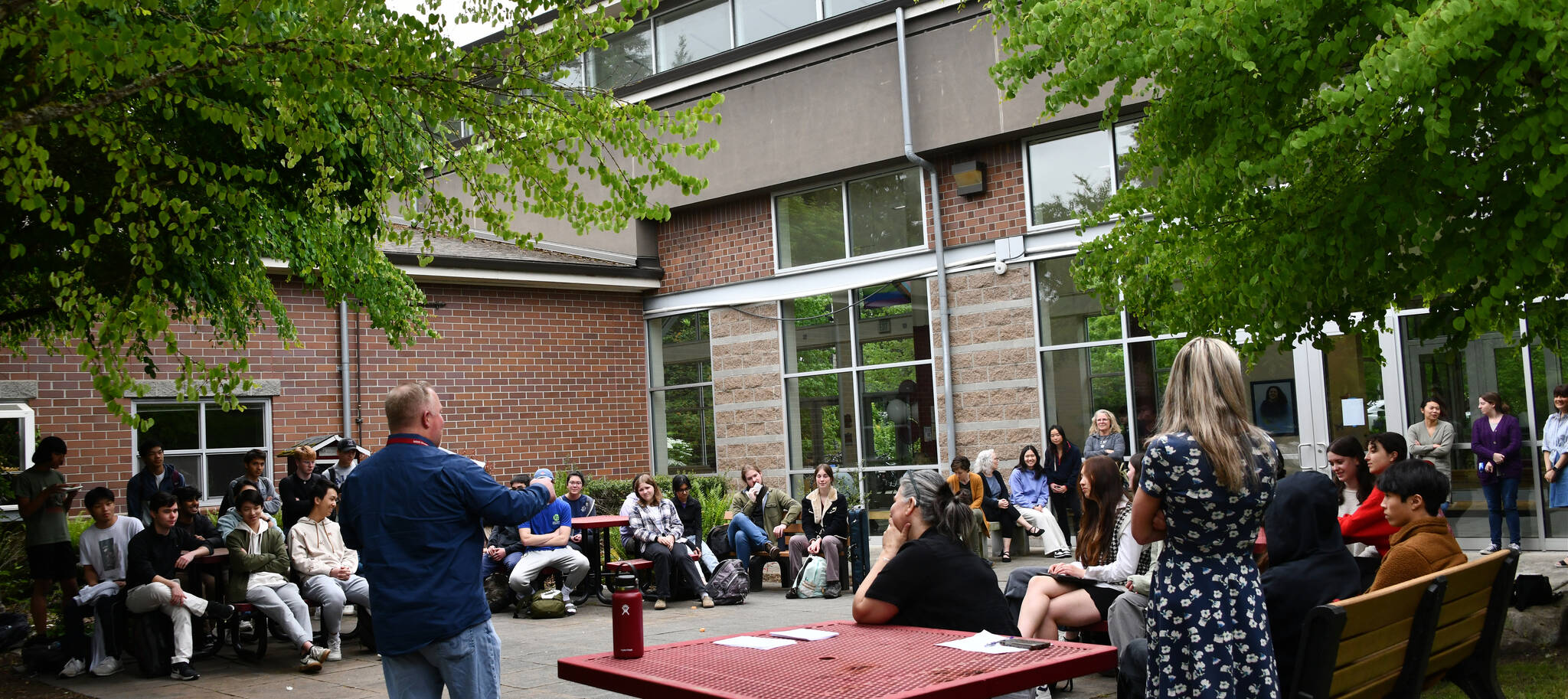 Mercer Island High School Principal Nick Wold announces a plethora of student achievements on May 13 in the school courtyard. Andy Nystrom/ staff photo