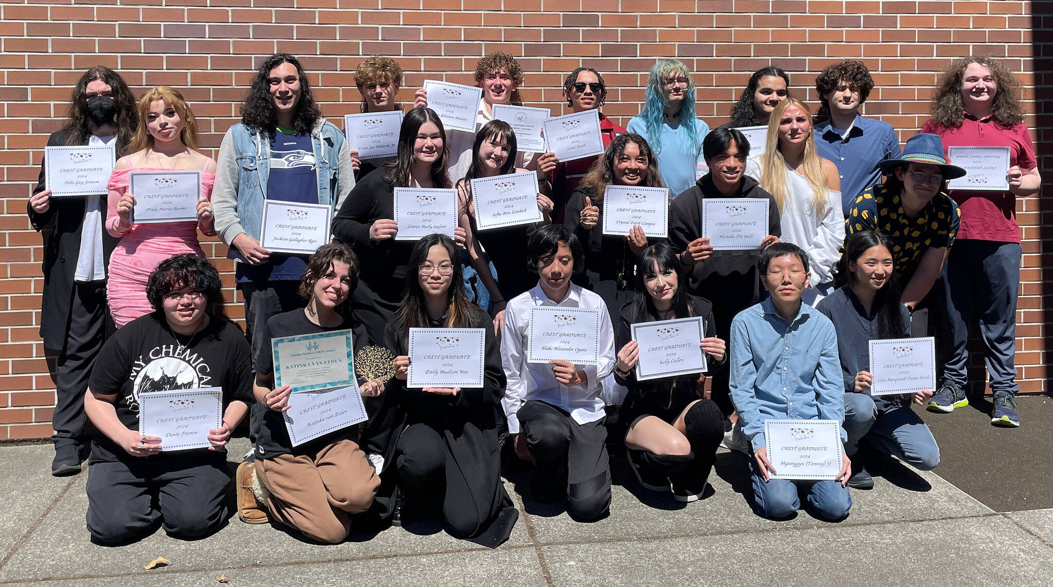 Mercer Island High School Crest Learning Center class of 2024 graduates: Left to right, front row: Dante Fromm, Kat vanEeden, Emily Woo, Blake Ogata, Kelly Cullen, Tommy Ji and Cora Marquardi Pirzio-Biroli. Middle row: Lauren Seafort, Sofia Landeck, Fei Campos, Nicky Mills, Delaney Williams and Fern Frame. Back row: Felix Joinson, Frida Barber, Jackson Agee, Brian Bilanski, Taven Glennon-Mulein, Cortez Smith, Willow Crew, Phoenix Baskin, Ethan Chernicoff and Alex Sytman. “As I look around, I can’t help but realize how lucky I am to have such a loving community around me and to have people that have always had my back and push me forward,” Agee said at the recent graduation ceremony. According to the MIHS website, Crest is specifically and carefully designed to offer a successful alternative pathway to graduation. Most coursework is completed in class to support the individualized, project-based learning and supportive structure of the Crest community students. Photo courtesy of the Mercer Island School District