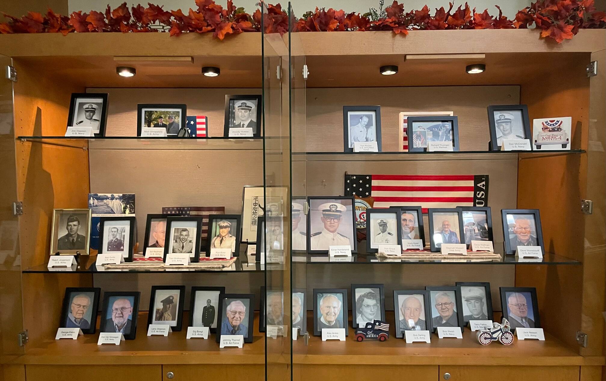 Mercer Islands Covenant Living at the Shores resident and employee veterans who served in the military are being recognized at the senior living community for Veterans Day. The community has created a display in their lodge with more than 30 photos of those residents and employees who have served in various branches of the military. The community has also placed American flags along the walkways to also honor veterans. The veterans at Covenant Living were honored during a ceremony on Nov. 11 for residents and families. Courtesy photo