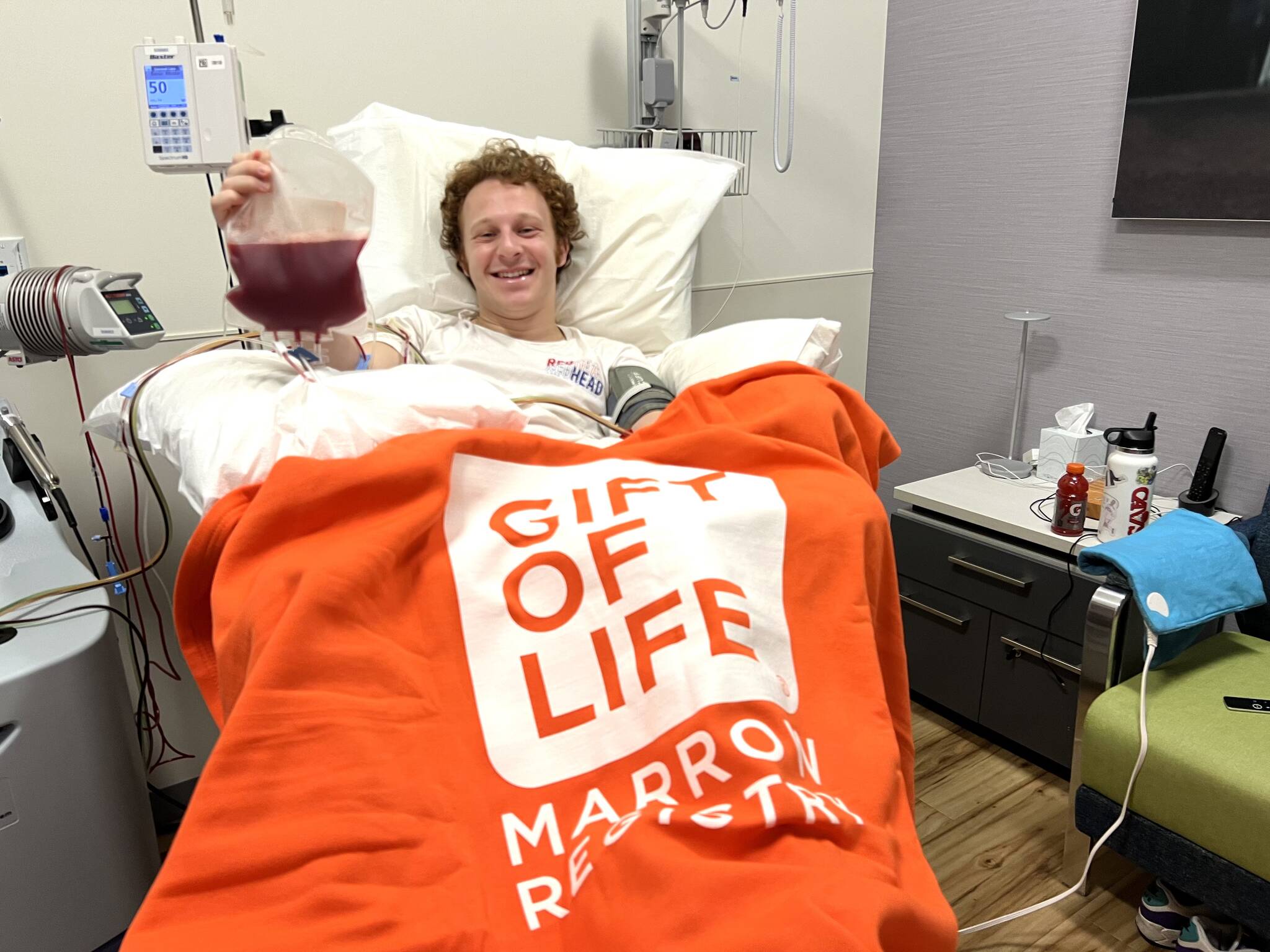 Mercer Island’s David Wolf makes a stem cell donation at the NMDP Seattle Collection Center earlier this month. The donation was sent to aid a 24-year-old leukemia patient. Photo courtesy of Lisi Mezistrano Wolf