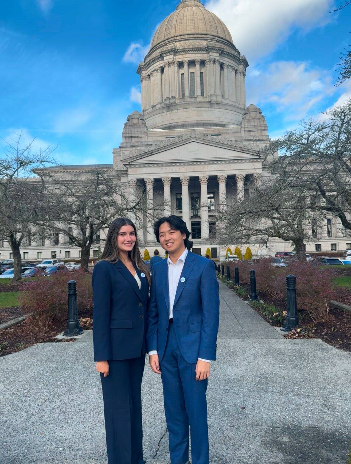 Mercer Island High School seniors Adelaide Swenson and Anthony Wang stand outside the Legislative Building in Olympia on Feb. 7. Courtesy photo