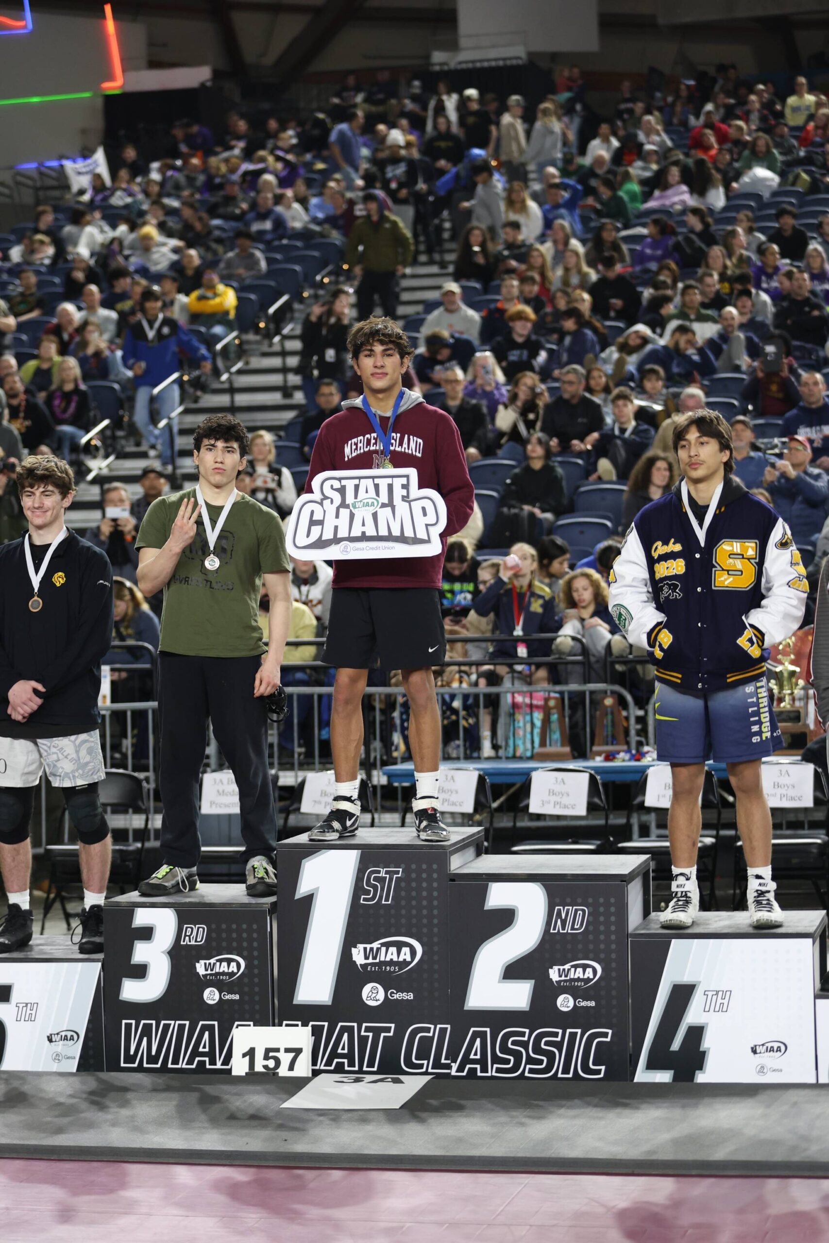 Mercer Island High School’s Chase Warnick stands atop the wrestling podium at state. Photo courtesy of Colton Knebel