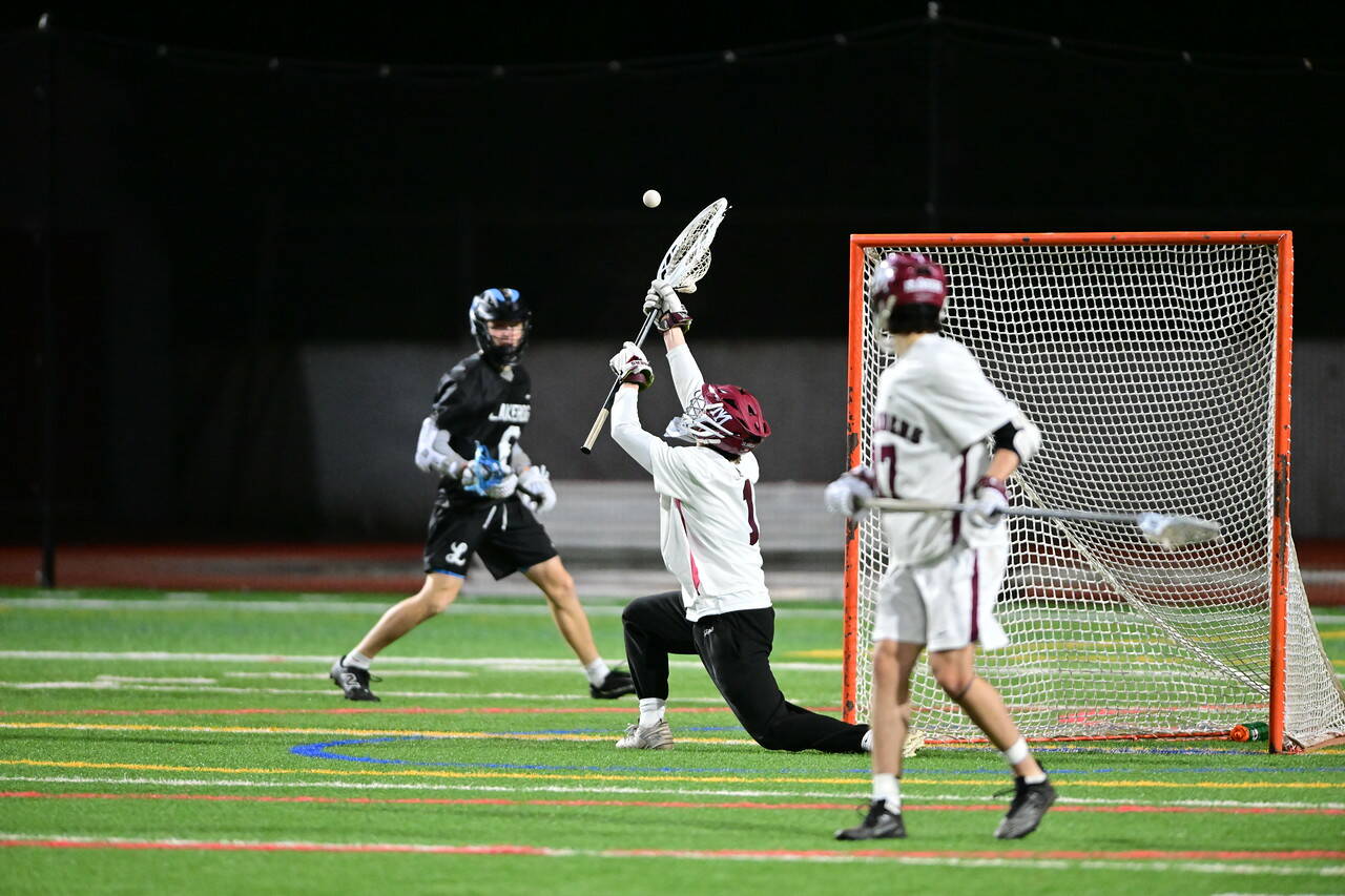 Mercer Island High School senior captain and goalkeeper Jess Geoghagan nets the ball during a recent lacrosse match. Photo courtesy of Jim Jantos