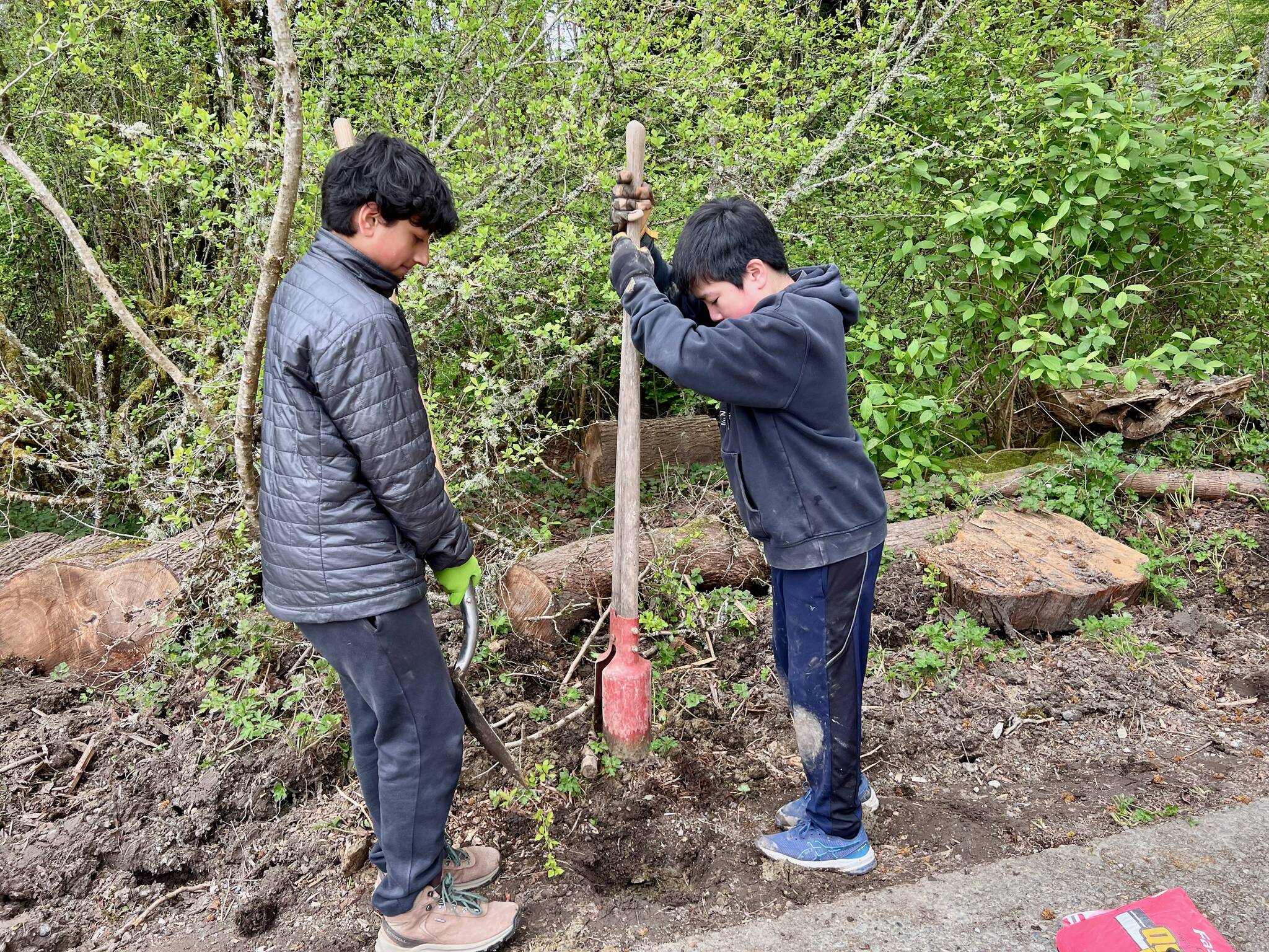 Vireen Pareek, left, and Bowen Nago hold the post hole digger. Courtesy photo