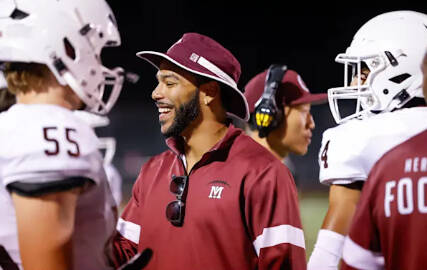 Victor Gamboa (center, left) has stepped into the role as the new Mercer Island High School (MIHS) head football coach. Athletic director Lindsey Blaine made the announcement on May 22. Gamboa, who was the defensive backs coach and defensive analyst for the Islanders the last three seasons, replaces DJ Mims — who has accepted the head coach position at Puyallup High School. Gamboa, who was the head coach of the MIHS girls flag football team this season, noted in a press release: “Having spent the past three years on the coaching staff, I have developed a deep appreciation for what makes Mercer Island such a unique and special place. Mercer Island is built on strong values, dedication and a deep sense of community — qualities I am proud to embrace in my new role. I am passionate about the game, committed to the growth of our student-athletes both on and off the field, and ready to lead with integrity, energy and purpose.” Photo courtesy of the Mercer Island School District