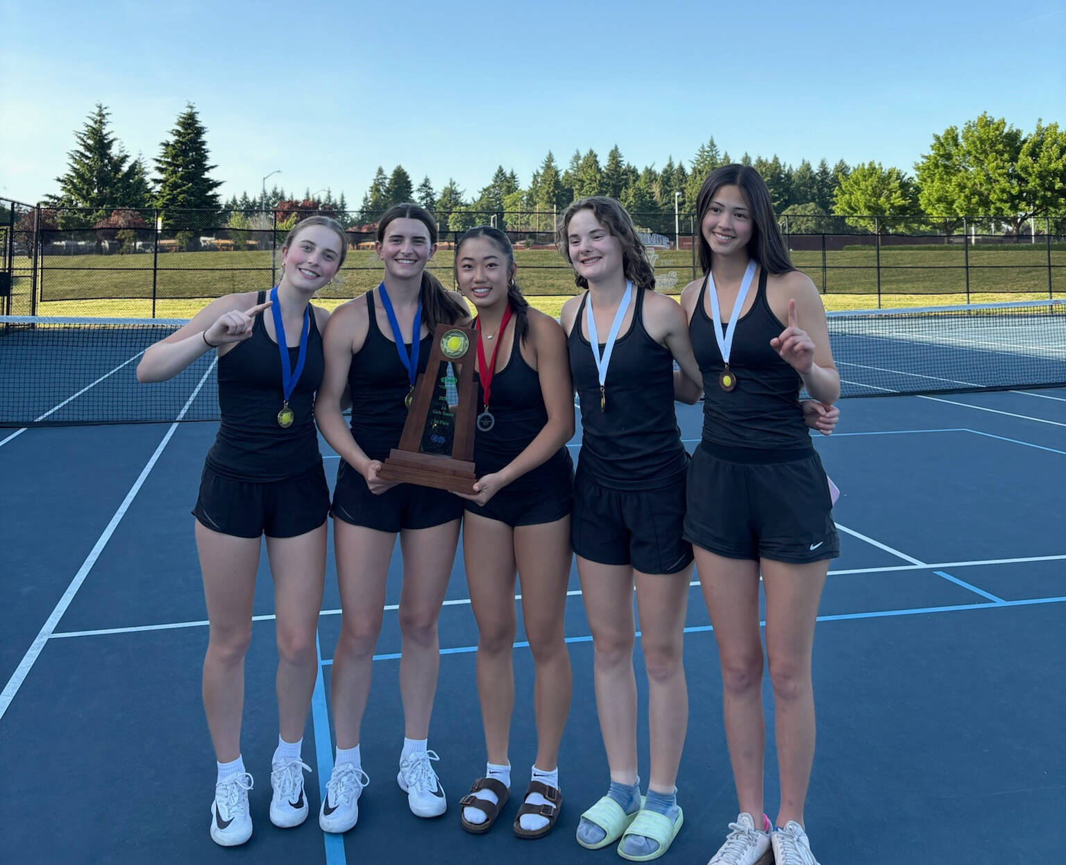 Mercer Island High School’s girls tennis team notched the 3A state championship on May 23-24 at the Vancouver Tennis Center. Rachel Garton/Sarah Garton took first in doubles, Caitlyn Ying placed second in singles and Mia Kinney/Jayne Tintle took fifth in doubles. It’s the third consecutive state team title for the girls and the second straight state doubles crown for the Garton sisters. From left to right, Sarah Garton, Rachel Garton, Ying, Tintle and Kinney. Courtesy photo
