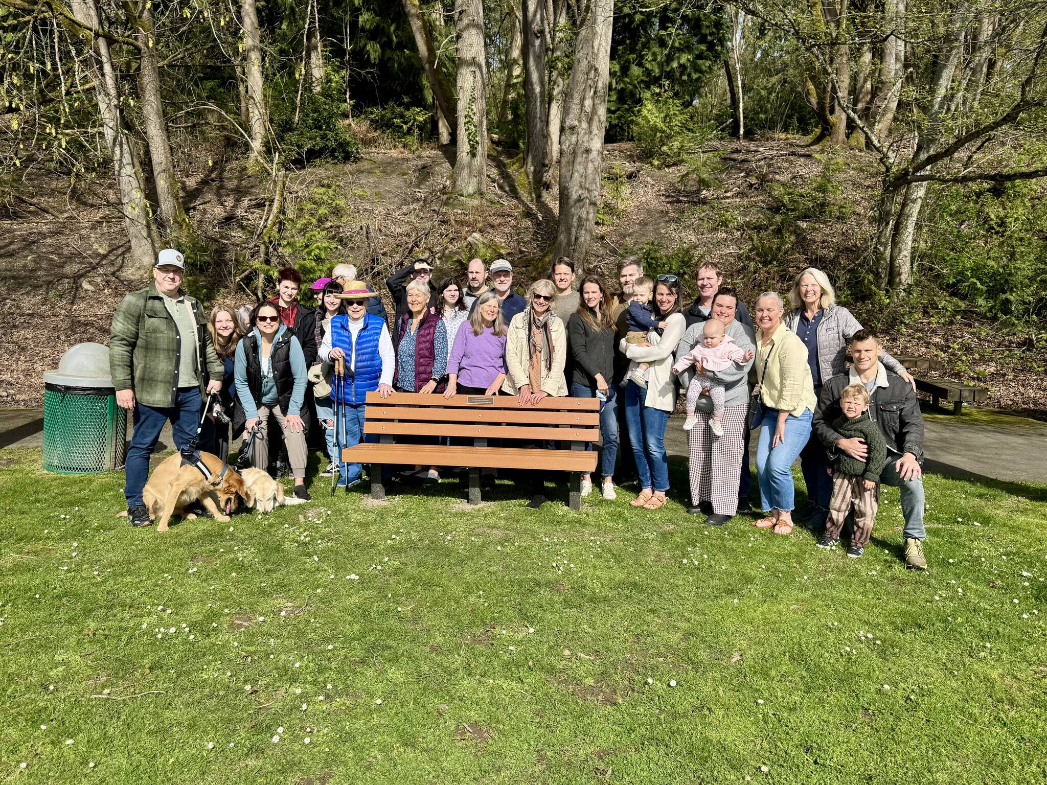 Members of Mercer Island’s Clarke family gather at Clarke Beach Park on April 5 to honor Nile Kinnick Clarke with a bench and plaque. Nile was a Mercer Island teacher and coach for more than 50 years who passed away in 2021 at the age of 74. Courtesy photo