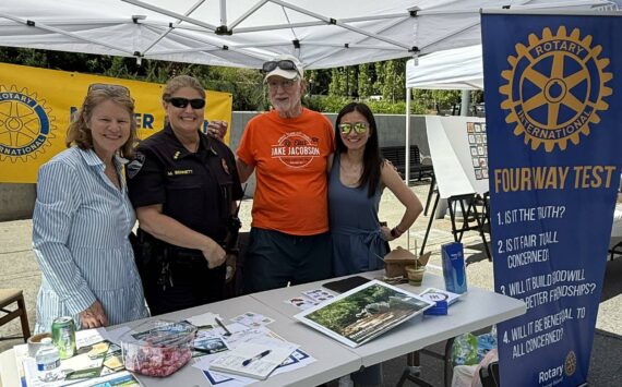 Rotarian Diane Tien, MI Police Chief Michelle Bennett, and Rotarians John Hamer and Linnea Augustine at Rotary’s Summer Celebration table. Courtesy photo.