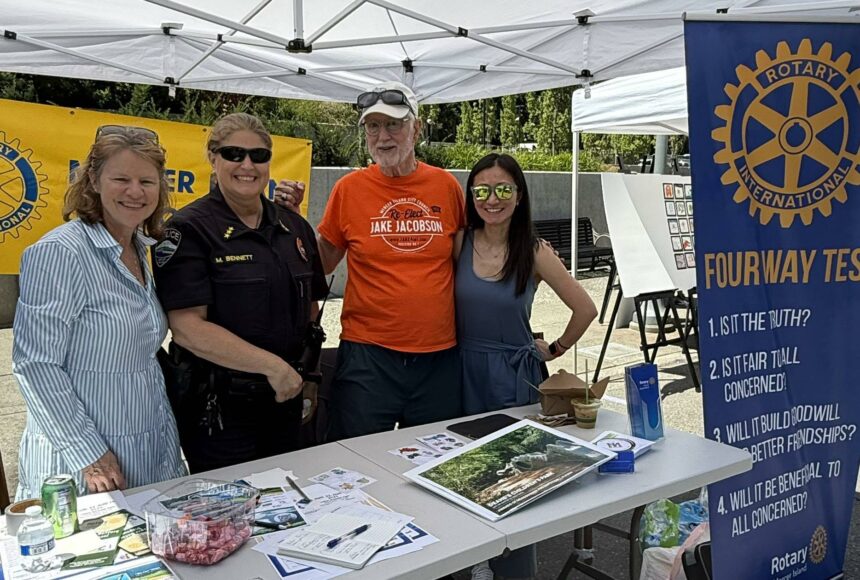 <p>Rotarian Diane Tien, MI Police Chief Michelle Bennett, and Rotarians John Hamer and Linnea Augustine at Rotary’s Summer Celebration table. Courtesy photo.</p>