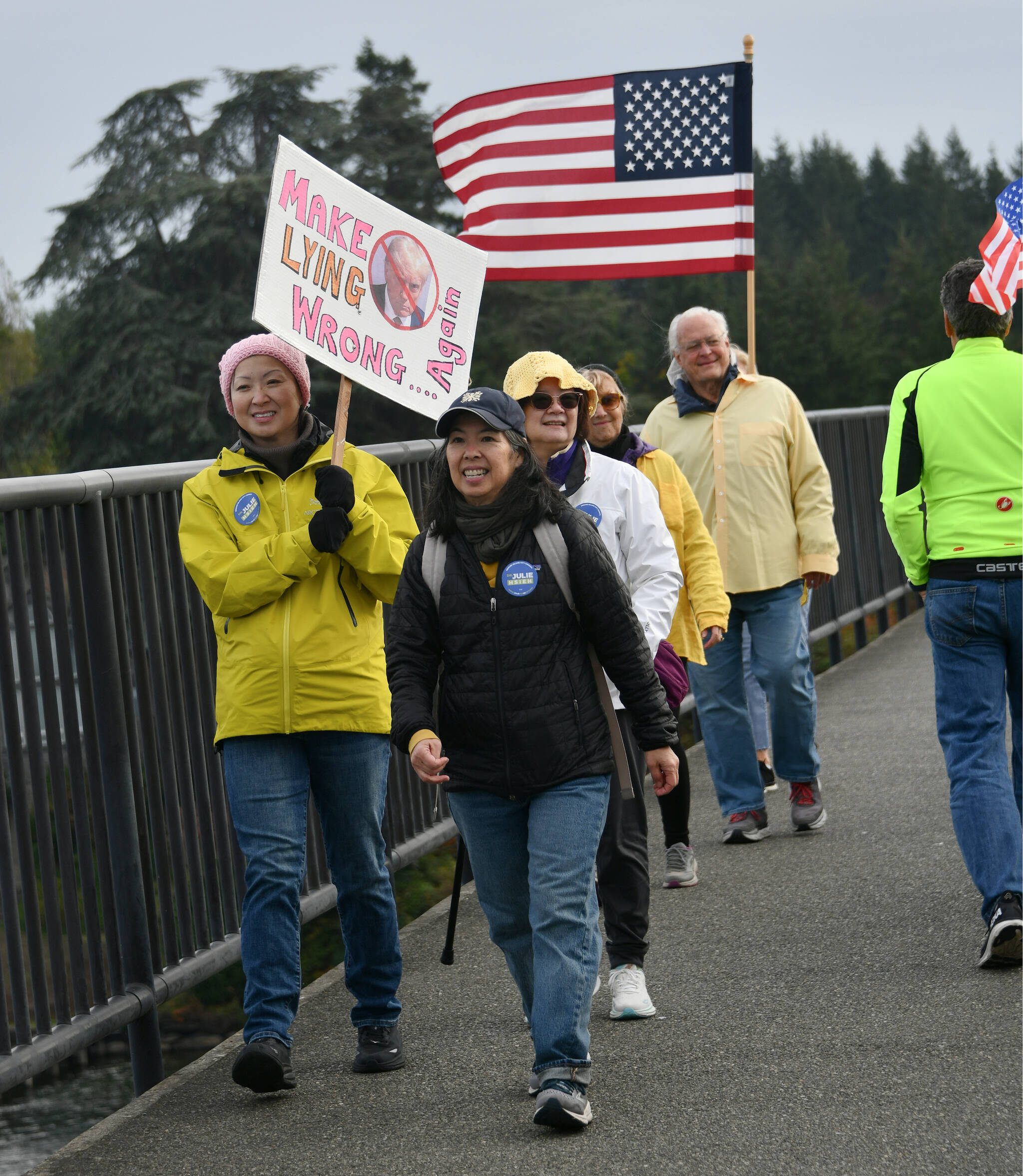 Mercer Island No Kings March participants walk across the Interstate 90 bridge coming from Aubrey Davis Park on Mercer Island on the morning of Oct. 18. Andy Nystrom/ staff photo