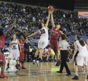 Mercer Island's Renae Tessem (30) tips the ball over Wilson's Tia Briggs (33) during the Islanders 3A state quarterfinal game on Thursday