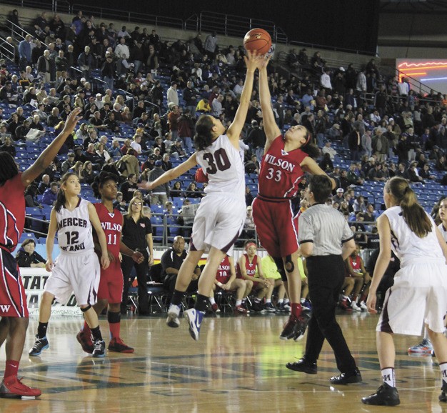 Mercer Island's Renae Tessem (30) tips the ball over Wilson's Tia Briggs (33) during the Islanders 3A state quarterfinal game on Thursday