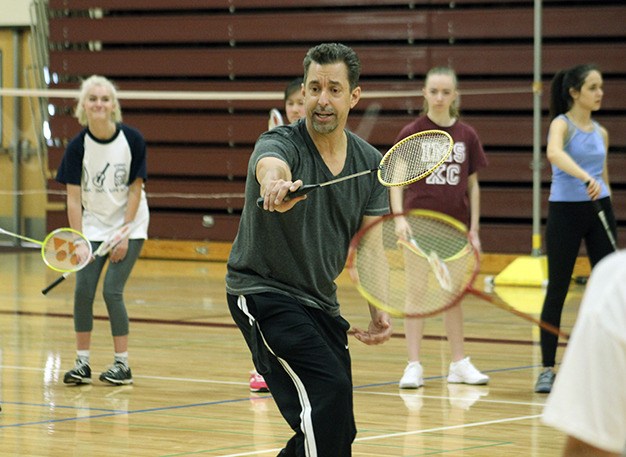Badminton coach Roy Newton leads his team through practice drills March 12 at MIHS.
