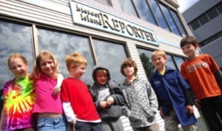 Girl Scouts and Cub Scouts from Den 2 of Pack 668 visit the Mercer Island Reporter May 26.