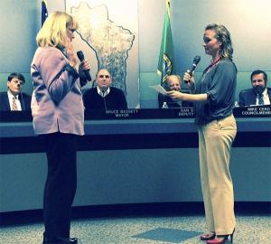 Deputy City Clerk Karin Roberts (right) swears in new City Councilmember Terry Pottmeyer on June 1.