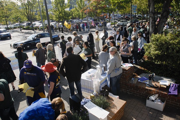 Protestors gathered on the corner of 78th Ave. S.E. and S.E. 28th Street Thursday morning near Rep. Dave Reichert's office. Protestors hosted a Depression-era unemployment line