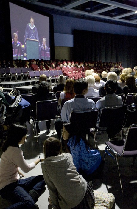 Friends and family watch and visit at the graduation ceremony for the Mercer Island High School class of 2010 Thursday.