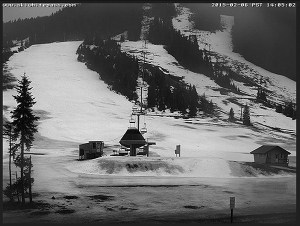 No snow. No skiers. The lack of snow this winter is clearly evident in this photo taken at Snoqualmie Pass in early February. It only snowed four days last month. Skiers headed out of state.
