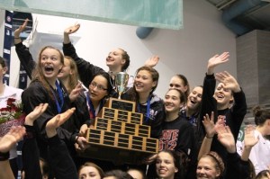 The Mercer Island girls swim team waves to their parents and fans after winning their fourth straigh state title on Saturday