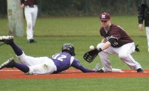 Mercer Island first baseman Alex Himstead tries to knock out a Garfield player during the Islanders non-conference win over the Bulldogs on Tuesday