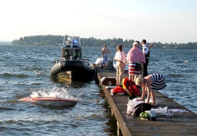 A classic wooden boat sinks off a dock at the north end of Mercer Island. All four of its occupants made it safely to the Island.
