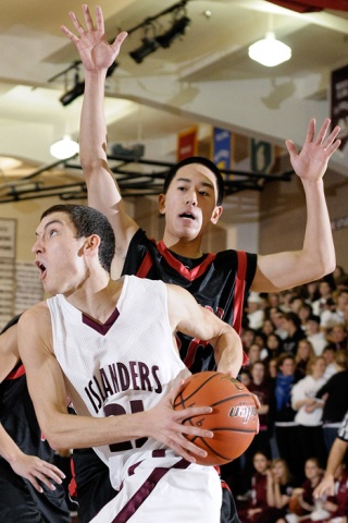 Islander guard Peter Zajac (21) drives to the basket against Ballard at Mercer Island