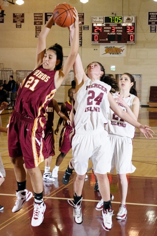 Islander guard Sarah Taylor (24) jumps for a rebound against Mount Tahoma forward Carrie Ojeda (21) at Mercer Island Wednesday.