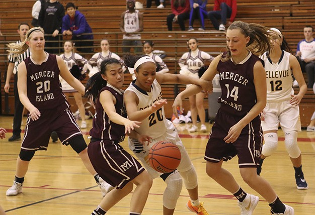 Bellevue’s Quinessa Caylao-Do (20) fights for a loose ball with Mercer Island’s Kailee Yan and Jess Blakeslee (14) Thursday