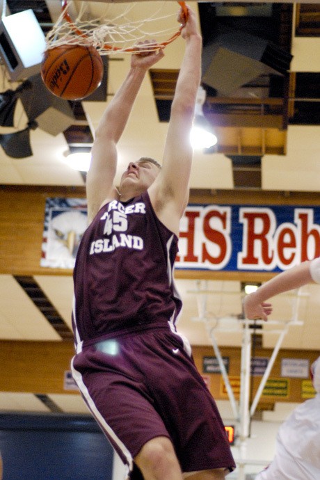 Islander center Kaj Sherman (45) slams in a two-handed dunk at Juanita during the Islanders’ win over the Rebels.