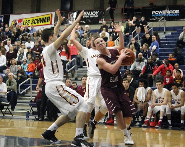 Mercer Island's Josh Stenberg struggles to find an opening against the Lakeside defense during the first half of the Islanders' consolation lose-out against the Lions Friday at Bellevue College. Lakeside won