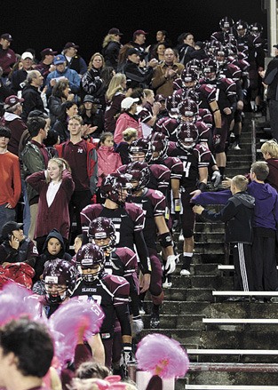 The Mercer Island High School football team walks in through the stands during the last home game on Oct. 21