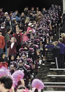 The Mercer Island High School football team walks in through the stands during the last home game on Oct. 21